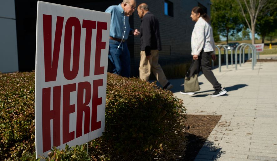 People visit an early voting polling place Friday, Oct. 23, 2026, in Nashville, Tenn. (AP Photo/George Walker IV)
