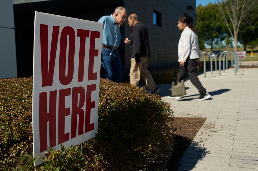 People visit an early voting polling place Friday, Oct. 23, 2026, in Nashville, Tenn. (AP Photo/George Walker IV)