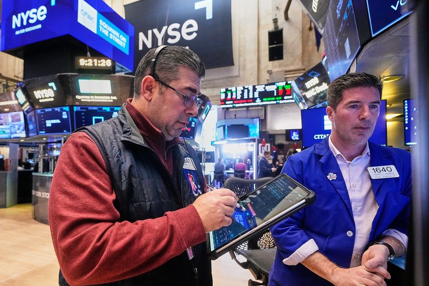 FILE - Trader Michael Capolino, left, and Specialist Thomas McArdle work on the floor of the New York Stock Exchange, Monday, Jan. 26, 2026. (AP Photo/Richard Drew, file)