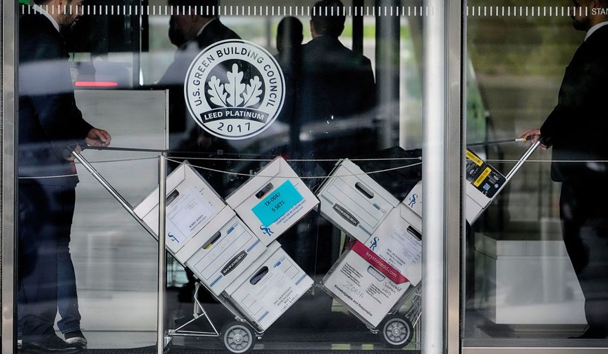 FILE - Case documents for a class-action lawsuit filed by "Sunday Ticket" subscribers are wheeled into federal court on June 17, 2024, in Los Angeles. (AP Photo/Damian Dovarganes, File)