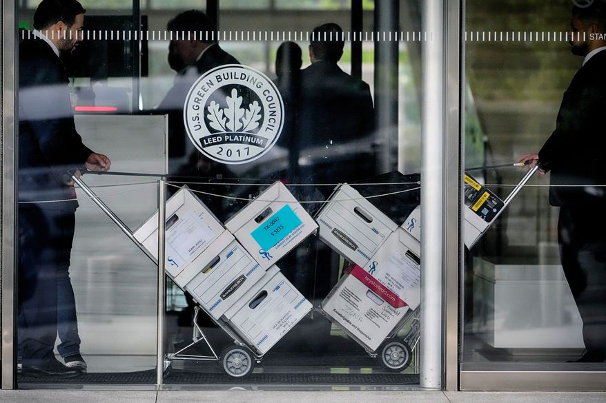 FILE - Case documents for a class-action lawsuit filed by "Sunday Ticket" subscribers are wheeled into federal court on June 17, 2024, in Los Angeles. (AP Photo/Damian Dovarganes, File)