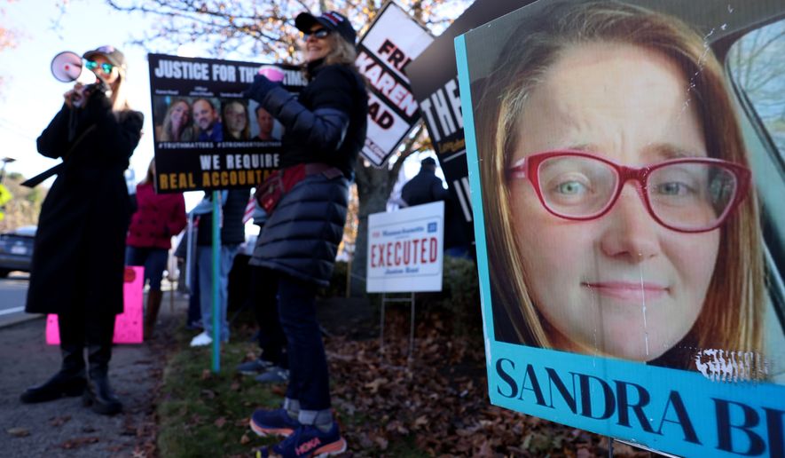 A photo of Sandra Birchmore is displayed during a Stronger Together Standout gathering, where the groups Free Karen Read, Justice for Sandra Birchmore & Justice for Juston Root protested together, outside of the Norfolk District Attorney's office, Nov. 13, 2024, in Canton, Mass. (Jessica Rinaldi/The Boston Globe via AP, File)