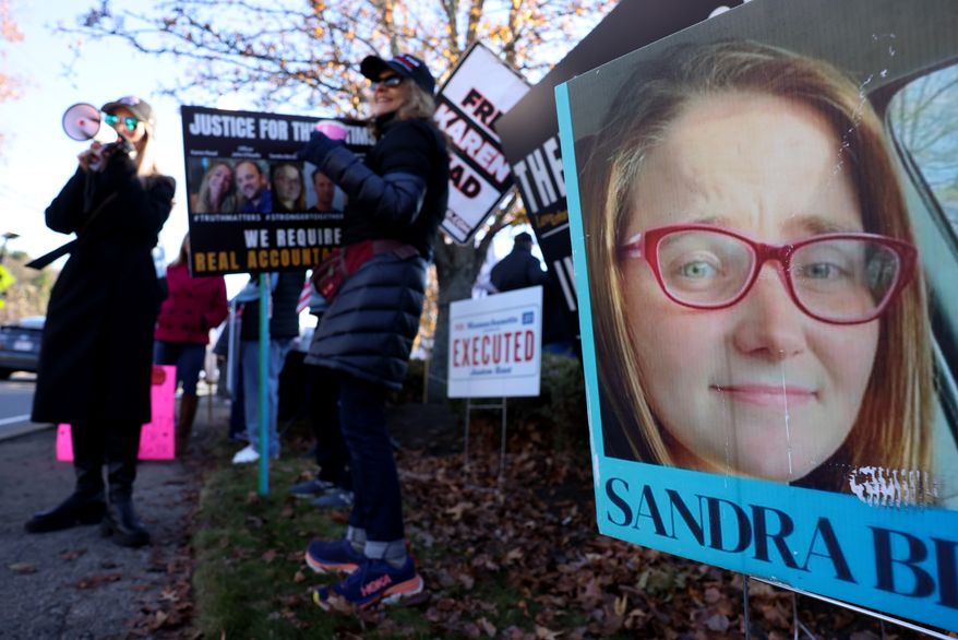 A photo of Sandra Birchmore is displayed during a Stronger Together Standout gathering, where the groups Free Karen Read, Justice for Sandra Birchmore & Justice for Juston Root protested together, outside of the Norfolk District Attorney's office, Nov. 13, 2024, in Canton, Mass. (Jessica Rinaldi/The Boston Globe via AP, File)