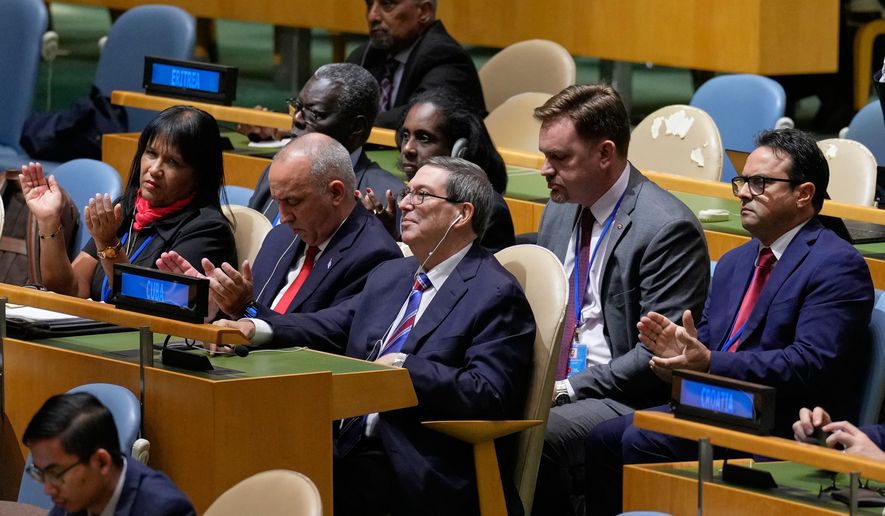 The Cuban delegation, including Cuban foreign minister Bruno Rodriguez Parrilla, center, reacts after a vote on ending the United States' blockade of Cuba at United Nations headquarters, Wednesday, Oct. 28, 2026. (AP Photo/Seth Wenig)