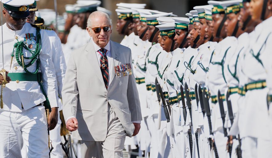 Britain's King Charles III inspects the guard of honor at the Royal Bahamas Defence Force Base in Nassau, Bahamas, Wednesday, Oct. 28, 2026. (AP Photo/Tim Aylen)