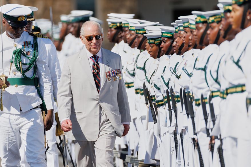 Britain's King Charles III inspects the guard of honor at the Royal Bahamas Defence Force Base in Nassau, Bahamas, Wednesday, Oct. 28, 2026. (AP Photo/Tim Aylen)