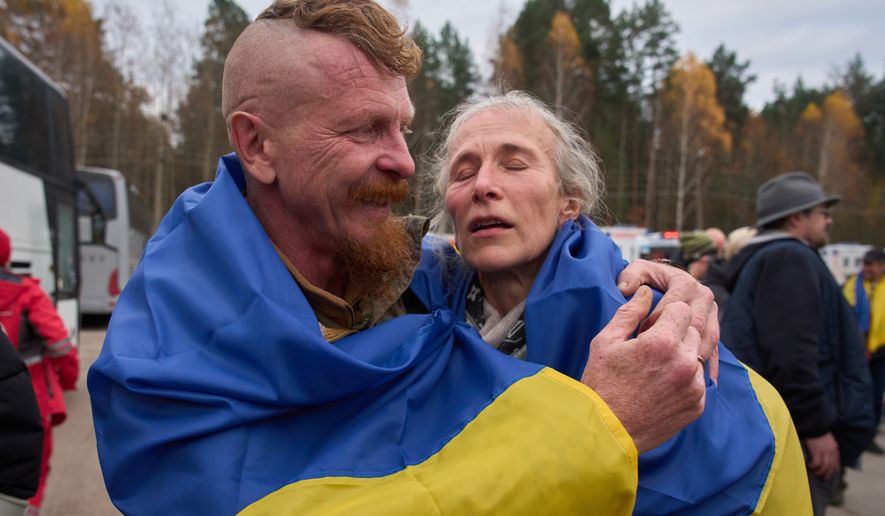 Ukrainian serviceman Dmytro hugs his wife Larysa after she being evacuated from their Russian-occupied hometown as they cross the Belarus-Ukraine border in Chernyhiv region, Ukraine, Saturday, Oct. 31, 2026. (AP Photo/Efrem Lukatsky)