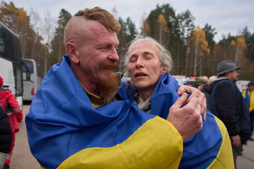Ukrainian serviceman Dmytro hugs his wife Larysa after she being evacuated from their Russian-occupied hometown as they cross the Belarus-Ukraine border in Chernyhiv region, Ukraine, Saturday, Oct. 31, 2026. (AP Photo/Efrem Lukatsky)
