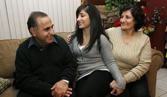 ** FILE ** In this 2008 file photo, Assyrian Christians Isaac Samow and his wife, Ziada, say their children, including Hala (center) still speak their language, but they fear the loss of their culture in their grandchildren in asylum in Modesto, Calif., and among other Assyrians fleeing the violence and persecution in the ancient homeland of Mesopotamia. (Associated Press)