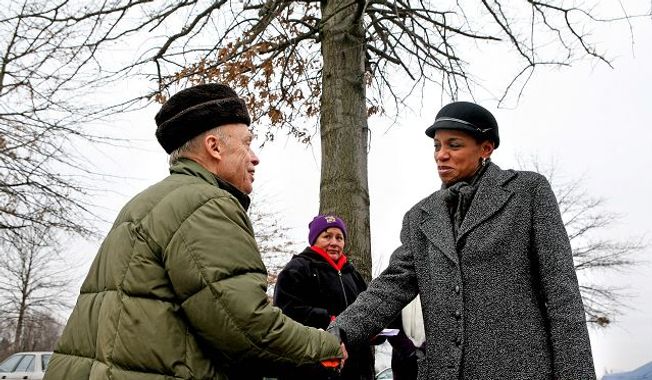 Donna Edwards, who ousted eight-term incumbent Rep. Albert R. Wynn in the 4th Congressional District, greeted supporter Theodore Lewis of Germantown outside Lake Seneca Elementary School Tuesday. (Katie Falkenberg/The Washington Times)