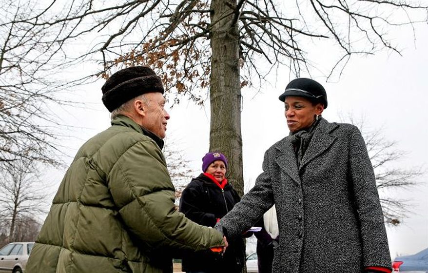 Donna Edwards, who ousted eight-term incumbent Rep. Albert R. Wynn in the 4th Congressional District, greeted supporter Theodore Lewis of Germantown outside Lake Seneca Elementary School Tuesday. (Katie Falkenberg/The Washington Times)