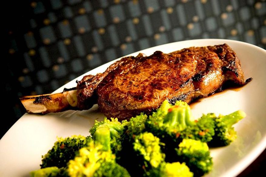 ** FILE ** The Greystone Grill's 20-ounce rib-eye steak is cowboy-cut but well-served with broccoli. (Michael Connor/The Washington Times)