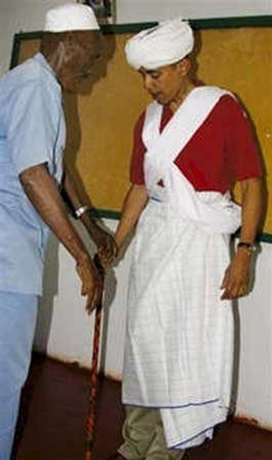 Associated Press
Sen. Barack Obama (right) was given local garb by retired chief Sheik Mohamed Hassan during a visit to northeastern Kenya in August 2006.
